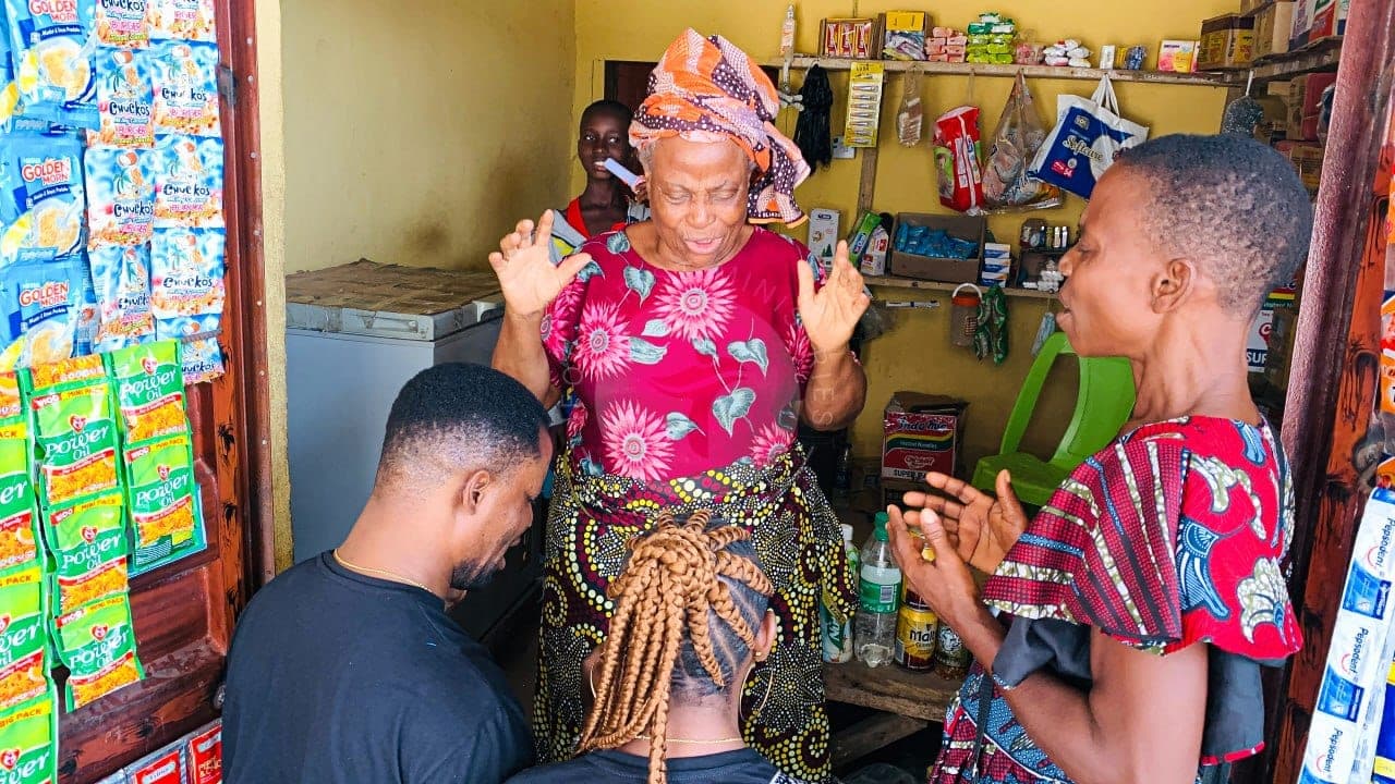Praying with a mother in her shop.
